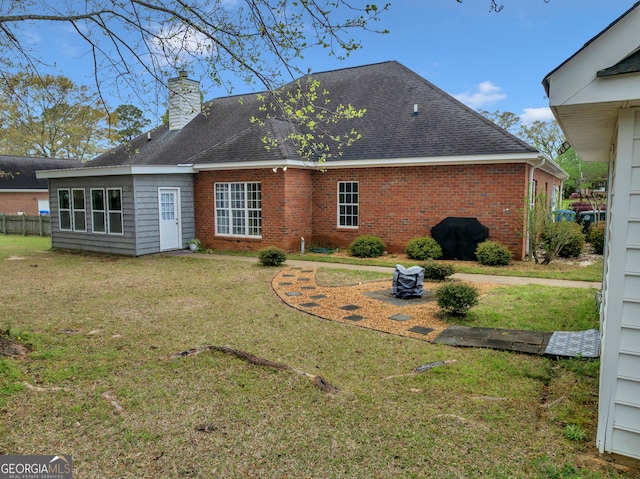 104 Red Fox Run, Dublin, GA 31021 - rear view of property featuring a chimney, brick siding, and roof with shingles