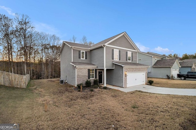 front facade featuring a front yard, a garage, and central AC unit