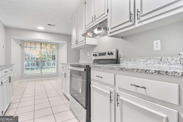 kitchen featuring white cabinets, stainless steel range with electric cooktop, and light tile patterned flooring