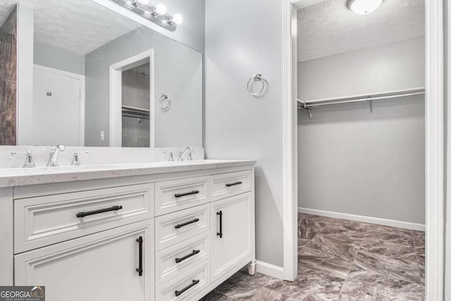 bathroom featuring vanity and a textured ceiling