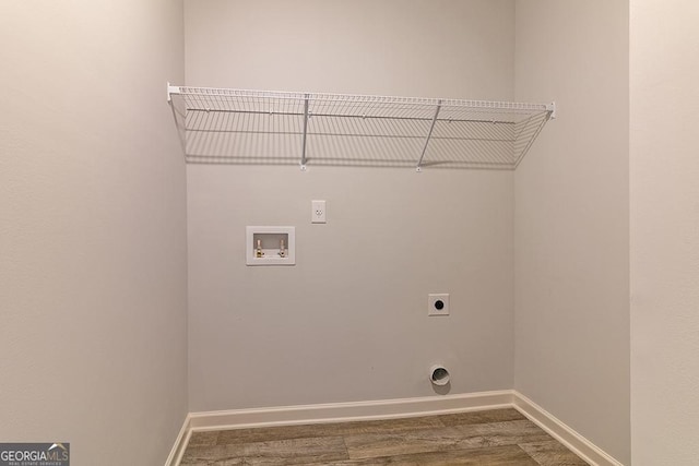 washroom with hookup for an electric dryer, hardwood / wood-style floors, and hookup for a washing machine