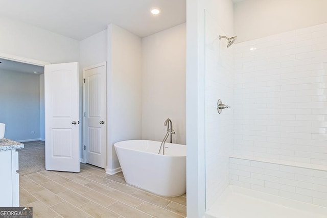 bathroom with plus walk in shower and vanity