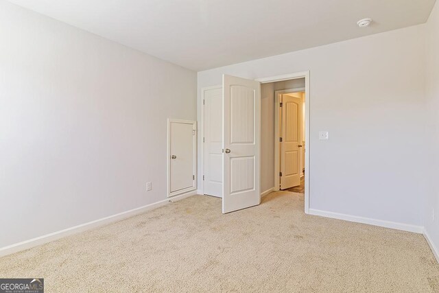 unfurnished bedroom featuring light colored carpet