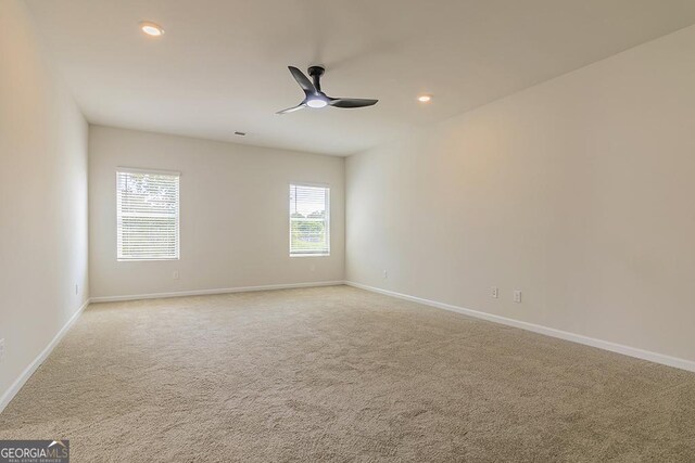 carpeted empty room with ceiling fan