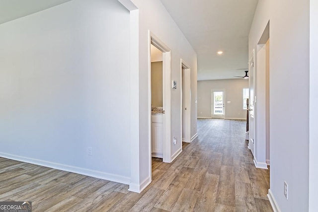 hallway with light hardwood / wood-style floors