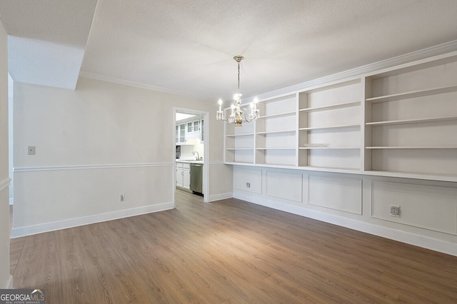 6851 Roswell Rd Unit D14, Atlanta, GA 30328 - unfurnished dining area with a chandelier, wood finished floors, a textured ceiling, crown molding, and built in features