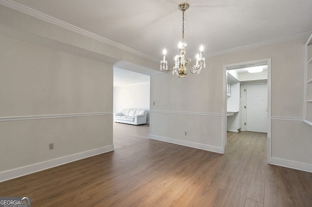 6851 Roswell Rd Unit D14, Atlanta, GA 30328 - unfurnished dining area featuring ornamental molding, a chandelier, and wood finished floors