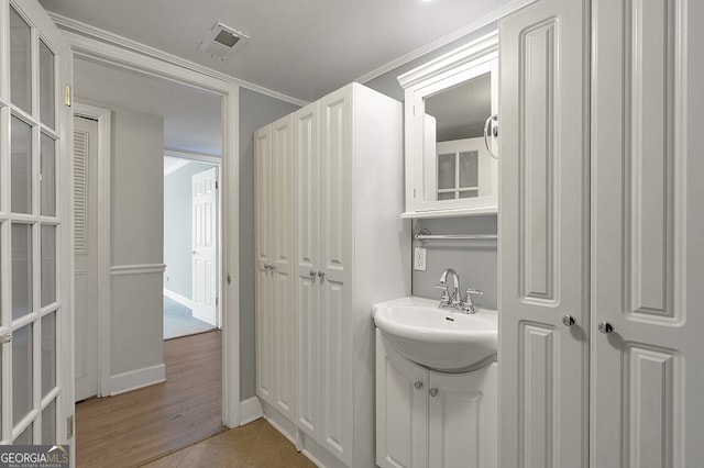 6851 Roswell Rd Unit D14, Atlanta, GA 30328 - bathroom featuring vanity, tile patterned flooring, and ornamental molding