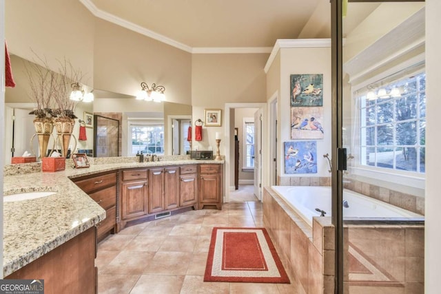 bathroom with a high ceiling, tile patterned floors, separate shower and tub, vanity, and ornamental molding