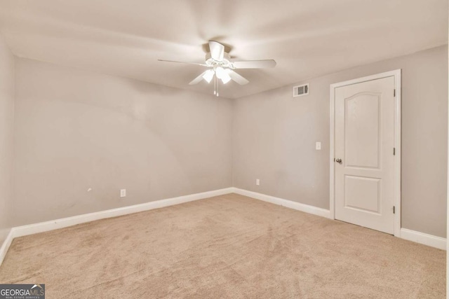 spare room with carpet flooring and ceiling fan