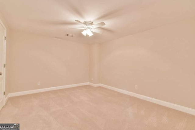 unfurnished room with ceiling fan and light colored carpet