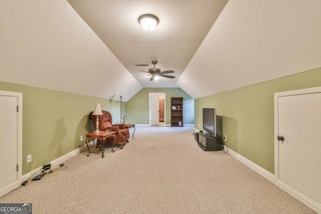 additional living space with light colored carpet, vaulted ceiling, and ceiling fan