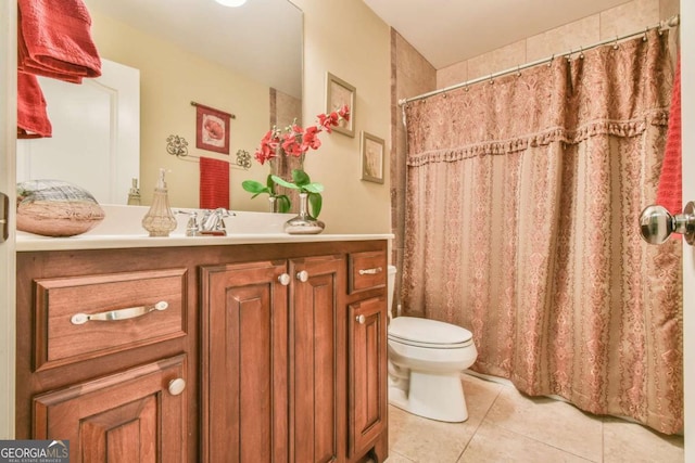 bathroom featuring tile patterned flooring, vanity, and toilet