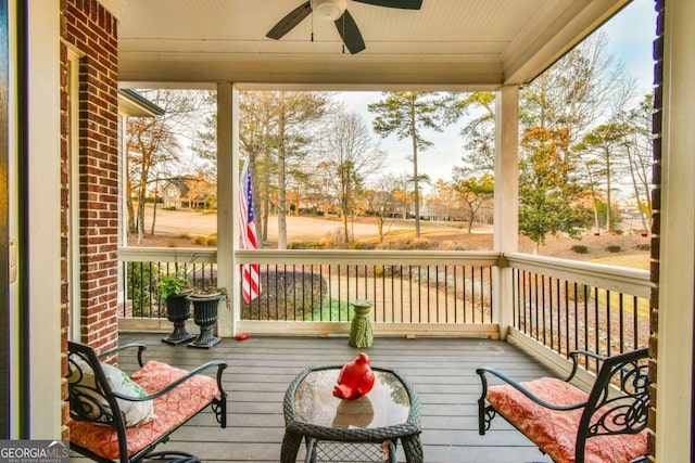 sunroom / solarium featuring ceiling fan