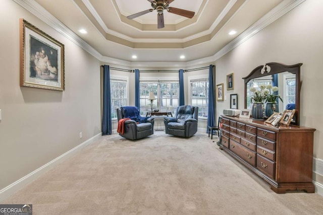 sitting room with ornamental molding and light carpet