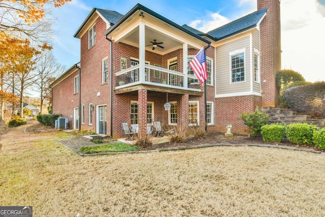 back of house with a lawn, ceiling fan, a balcony, cooling unit, and a patio area