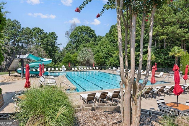 view of pool featuring a patio and a water slide