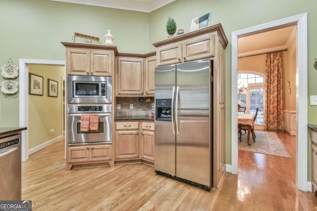 kitchen featuring light brown cabinetry, stainless steel appliances, and light hardwood / wood-style flooring