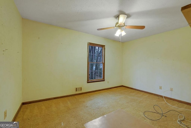 unfurnished room with light colored carpet and ceiling fan