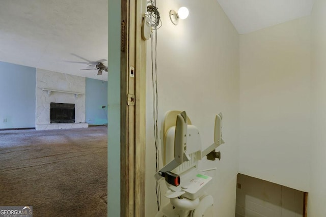 bathroom with vaulted ceiling, a premium fireplace, and ceiling fan