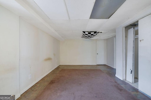 basement featuring a paneled ceiling