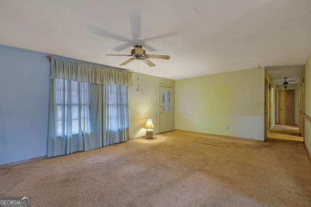 empty room with light colored carpet and ceiling fan