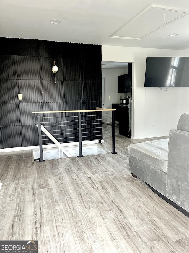 unfurnished living room featuring wooden walls and hardwood / wood-style flooring