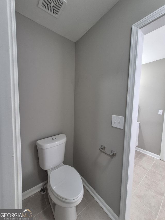 bathroom with tile patterned floors and toilet