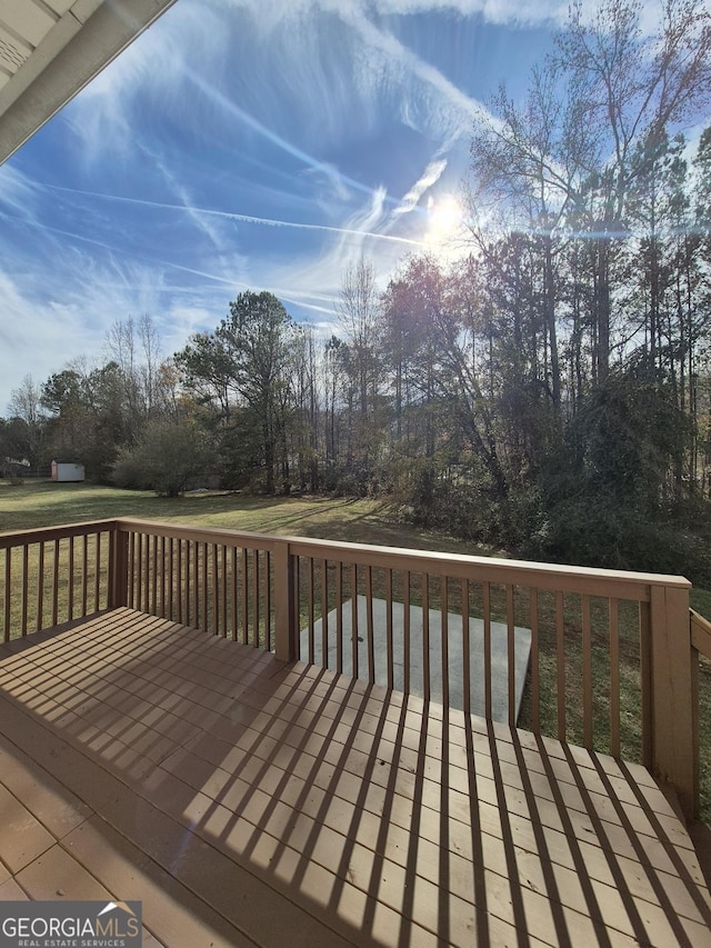 wooden terrace with a lawn