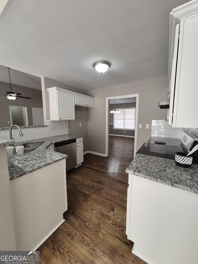 kitchen featuring dark hardwood / wood-style flooring, light stone counters, white cabinetry, and appliances with stainless steel finishes