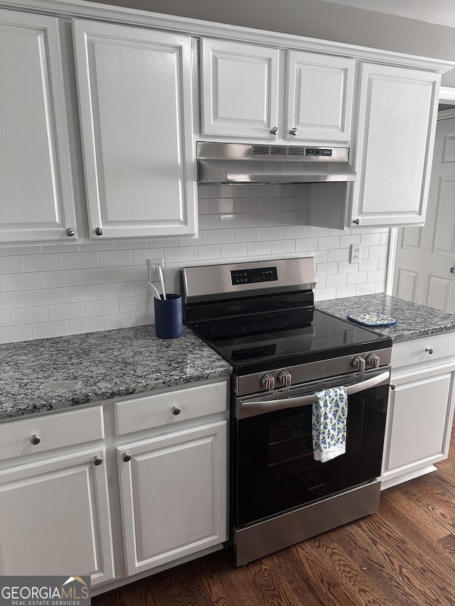 kitchen featuring dark hardwood / wood-style floors, white cabinetry, and stainless steel stove