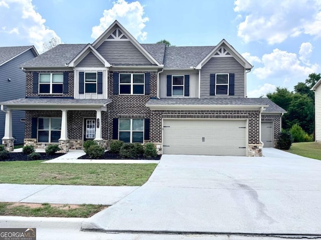 craftsman-style home featuring a front yard and a garage