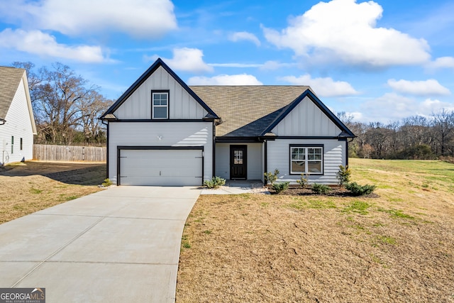 view of front of property featuring a front lawn and a garage