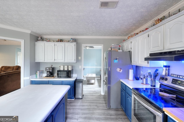 kitchen with blue cabinets, under cabinet range hood, visible vents, and appliances with stainless steel finishes