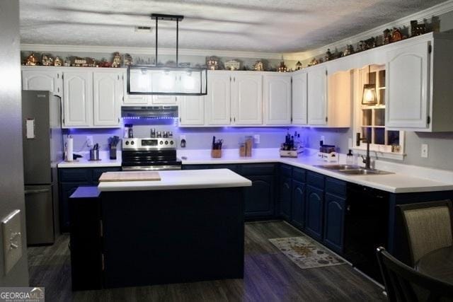 kitchen featuring sink, decorative light fixtures, a kitchen island, white cabinetry, and stainless steel appliances