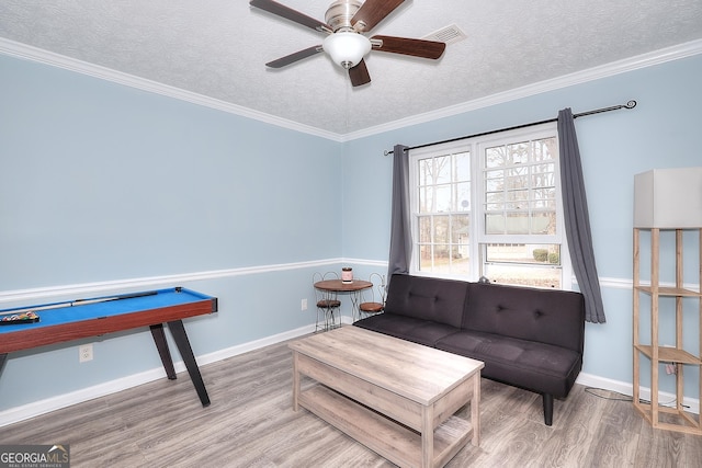 sitting room with crown molding, ceiling fan, a textured ceiling, and hardwood / wood-style flooring