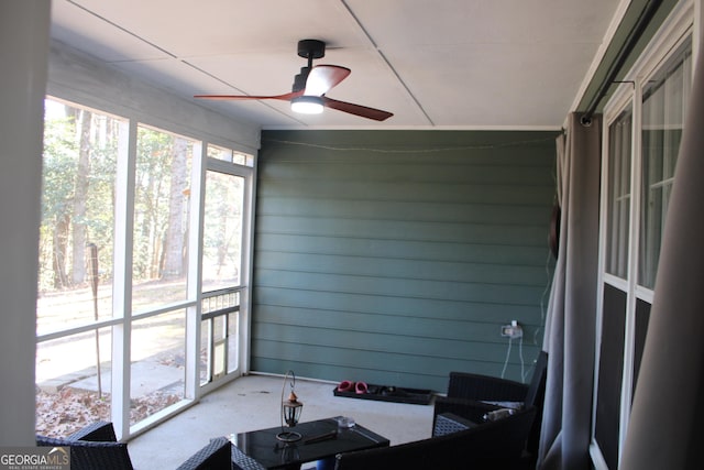 sunroom / solarium featuring ceiling fan