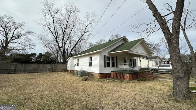 view of home's exterior featuring a lawn and covered porch