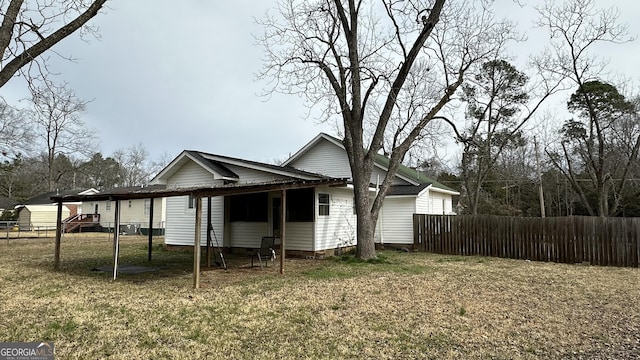 rear view of house with a yard