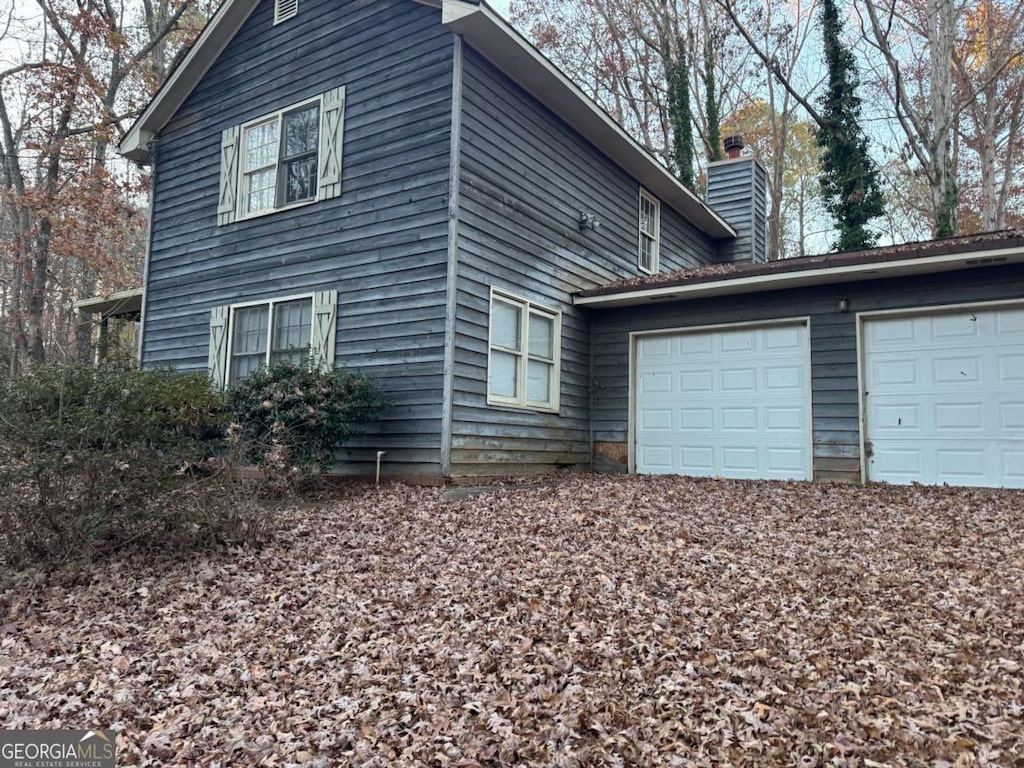 view of side of property with a garage