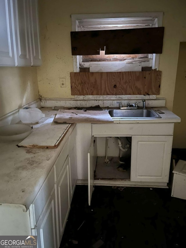 kitchen with white cabinetry and sink