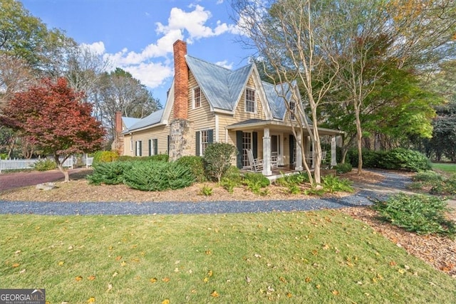 view of front of home featuring covered porch and a front yard