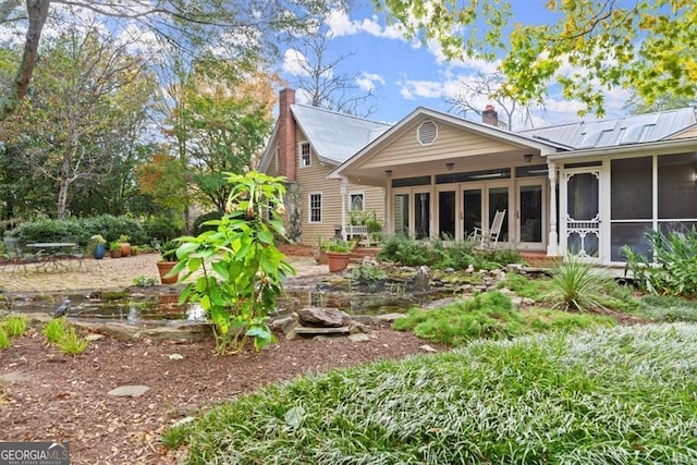 rear view of property with a sunroom