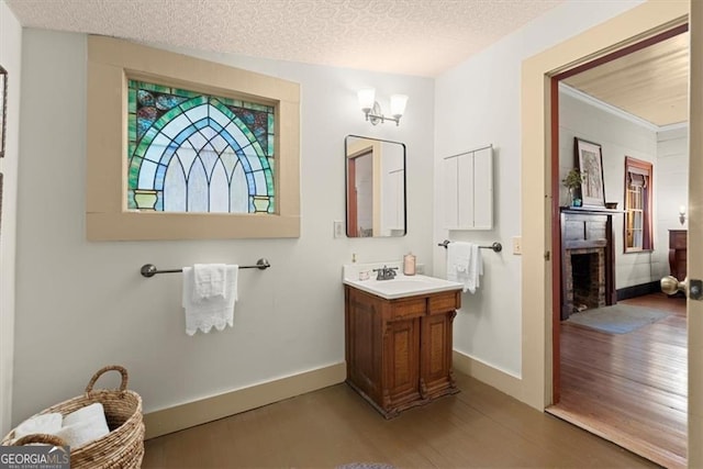 bathroom with a textured ceiling, vanity, and hardwood / wood-style flooring