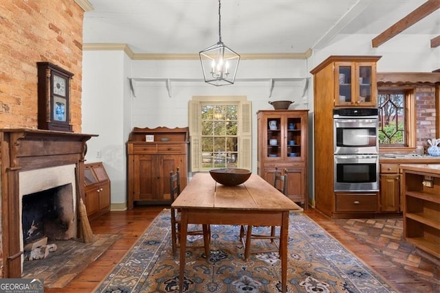 dining space featuring beamed ceiling, plenty of natural light, crown molding, and a notable chandelier