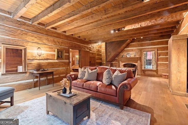 living room with wooden ceiling, beamed ceiling, wood-type flooring, and wood walls