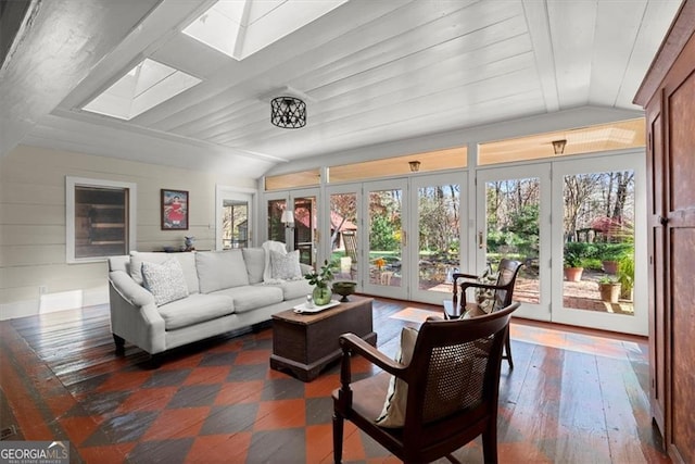 living room featuring french doors, lofted ceiling with skylight, wooden walls, and hardwood / wood-style floors