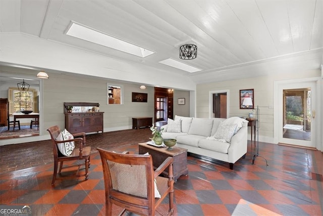 living room with a healthy amount of sunlight and lofted ceiling with skylight