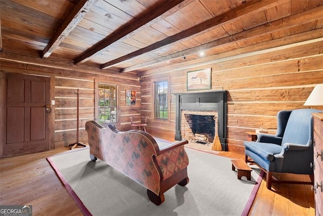 living room featuring a brick fireplace, wooden walls, wood-type flooring, wooden ceiling, and beamed ceiling