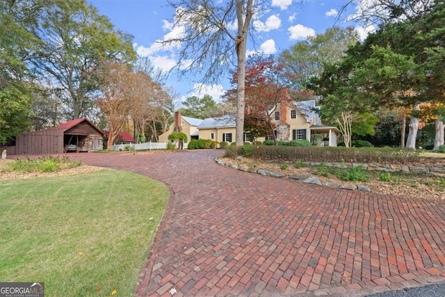 view of front facade with an outbuilding and a front yard